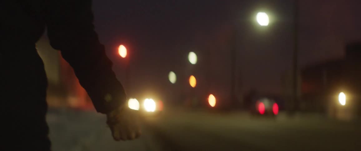 A person is hitchhiking at night