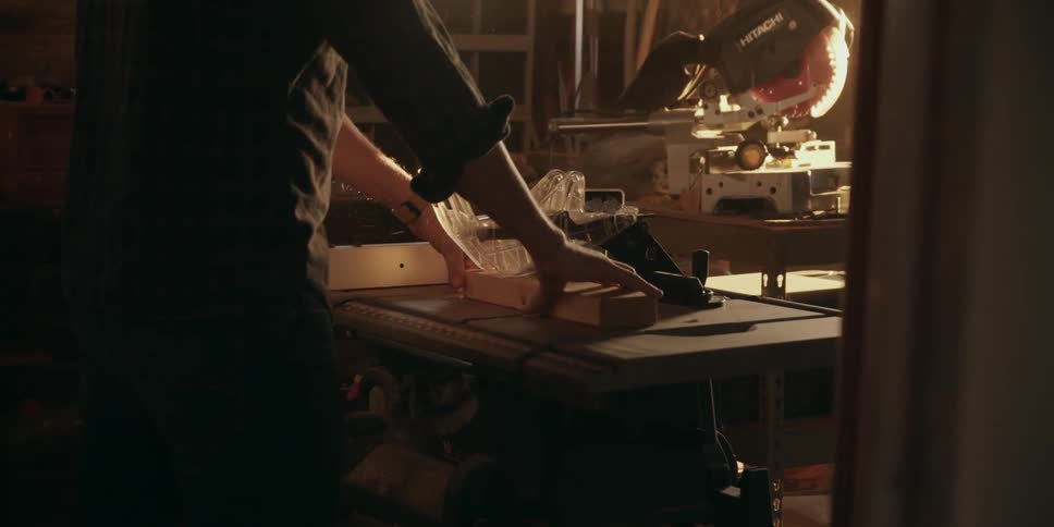 A man is playing with wood at night