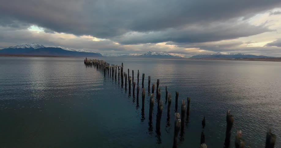 The broken pier has many stakes in the water