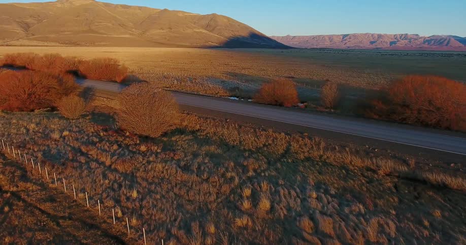 A car travels on a desert road