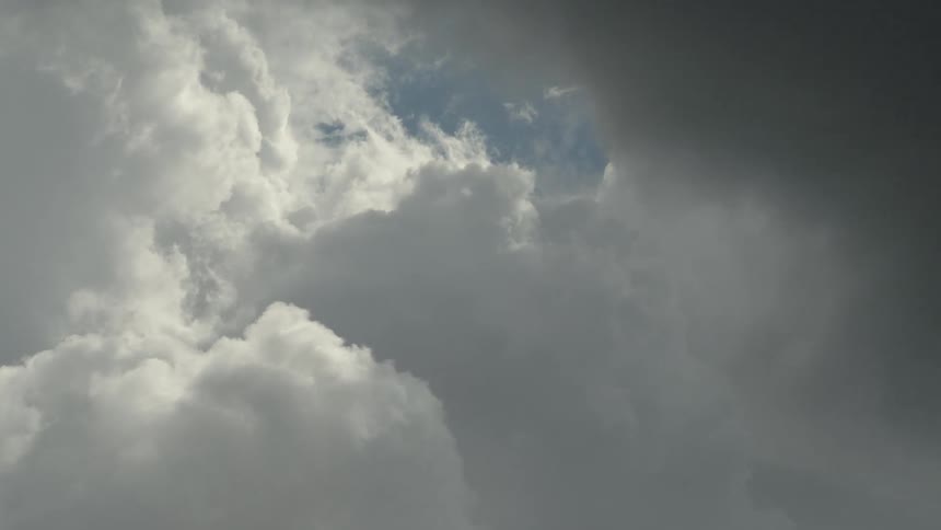 Clouds are moving in the sky with a small patch of blue between the clouds