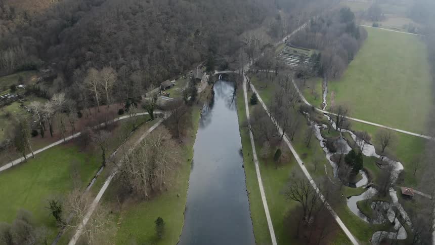 Roads line both sides of the river and extend into the trees