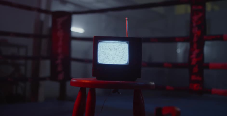 Television showing static on its screen in a dim room