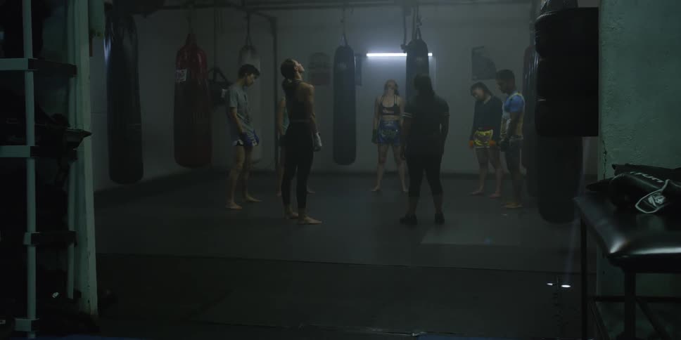 A group of people warm up in a gym
