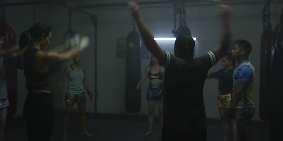 A group of people warm up in a gym