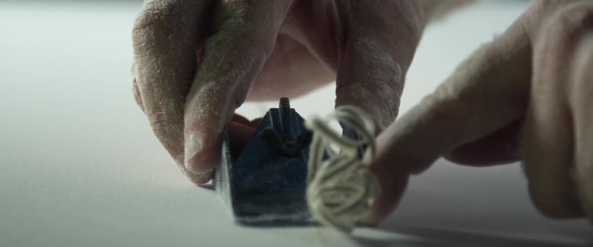 A person shaving wood
