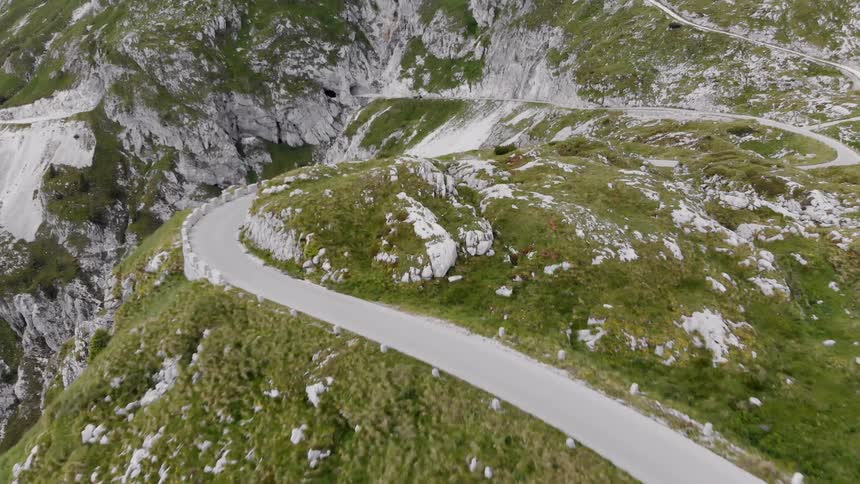 Vehicle drives over winding road through the mountains