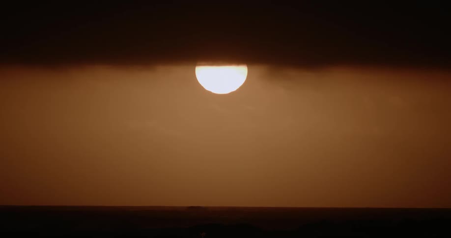 The sun sets over the horizon