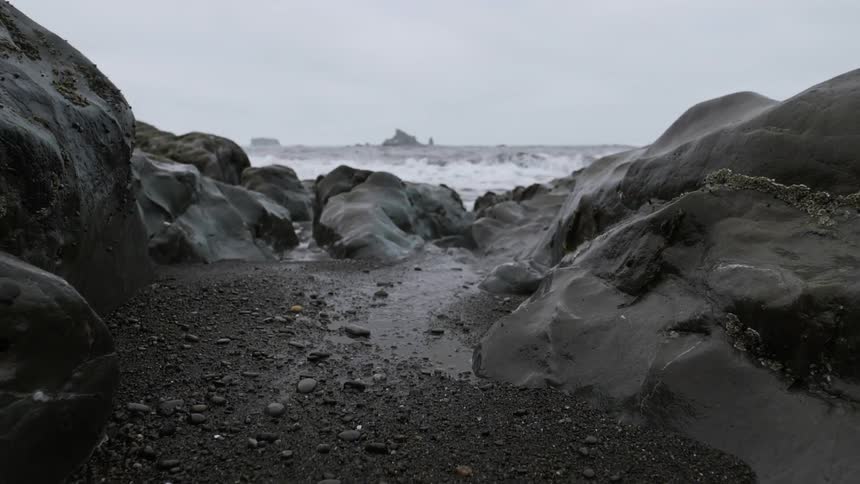 The water is rough on the rocky shore