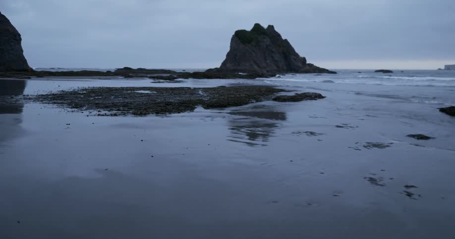 Ocean waves wash ashore a sandy beach