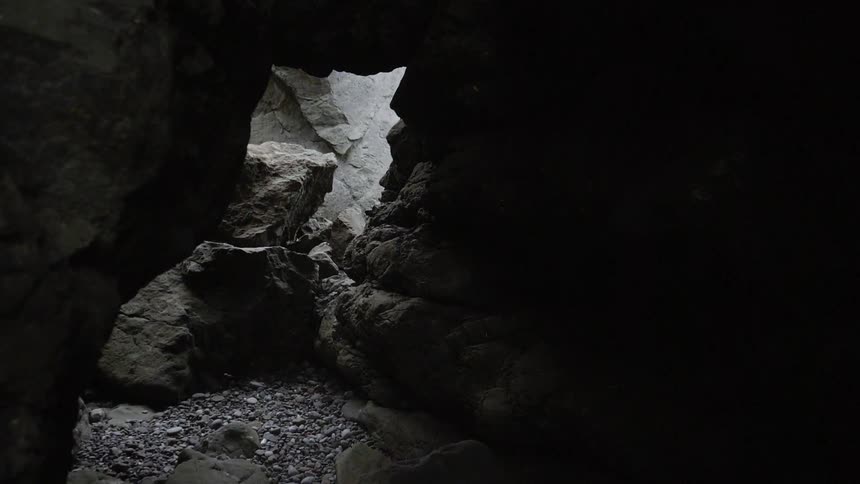 Rocks cover the ground of a cave