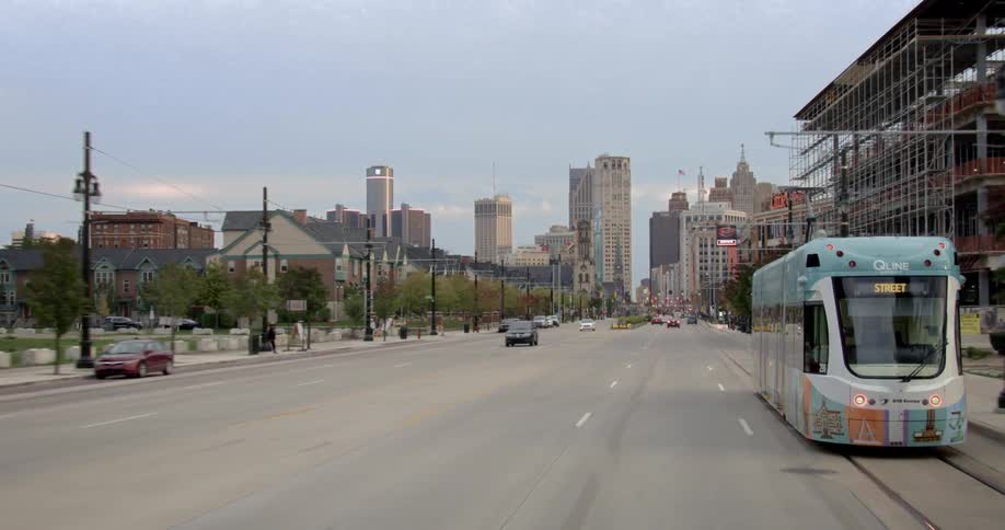 Cars drive on a city street