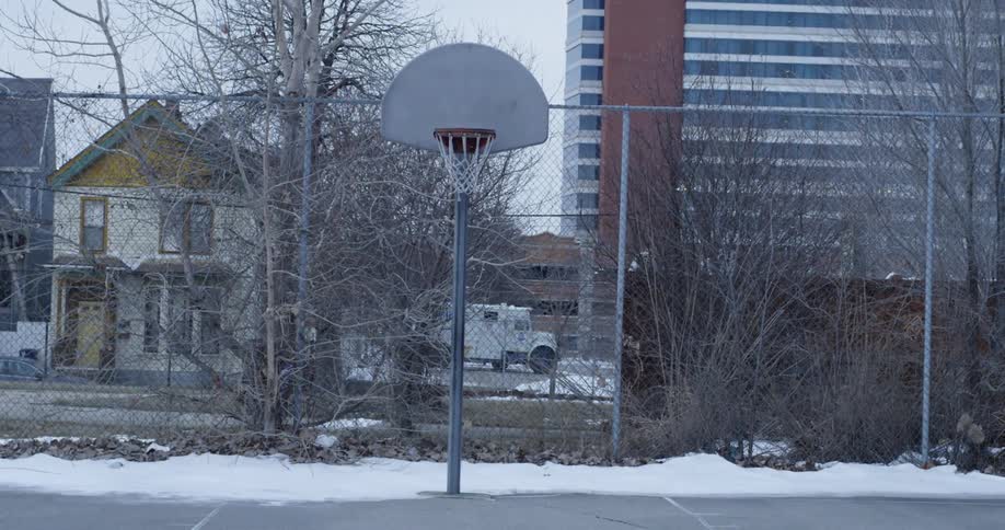 A basketball hoop sits on a snowy court