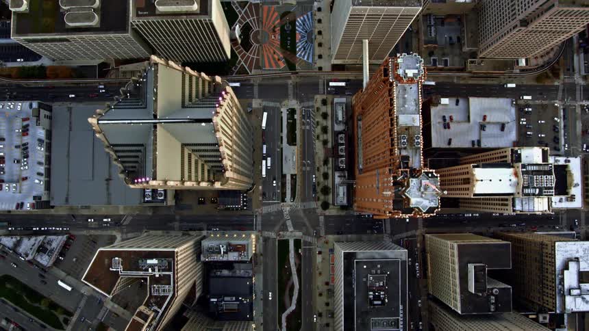 Cars drive by city skyscrapers