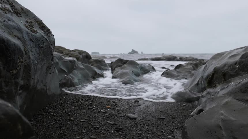 Water splashes onto a rocky shore