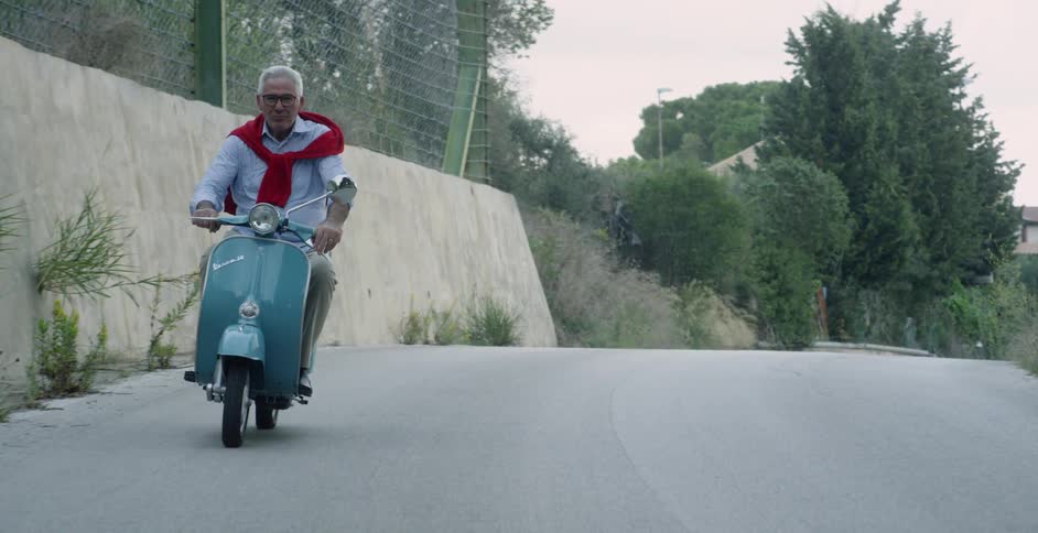 A man rides a scooter
