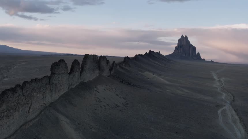The sun sets over rock formations in the desert