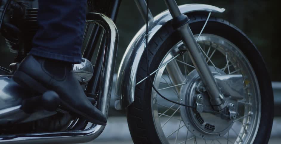 A man sits on a motorcycle