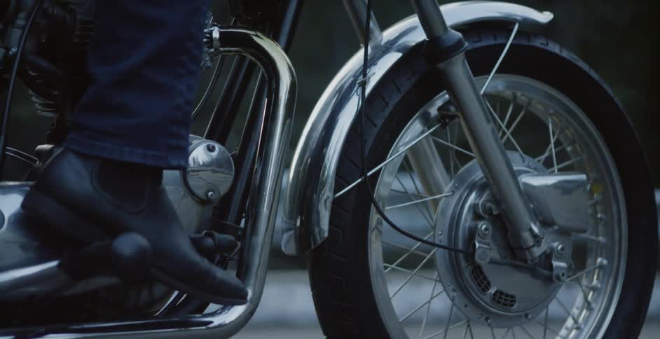 A man sits on a motorcycle