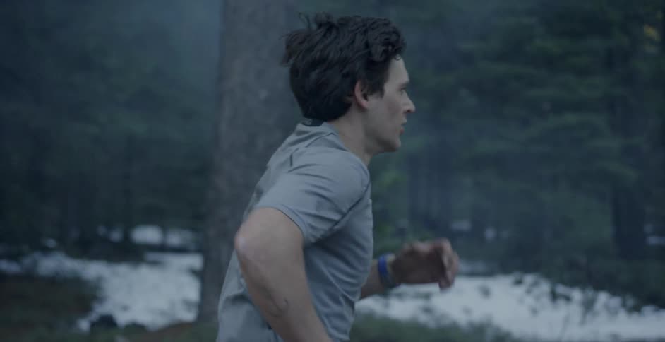 A man jogs outside in the woods