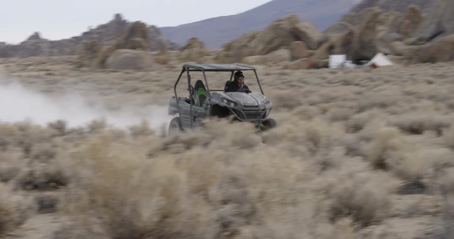 Four wheeler speeds across desert floor