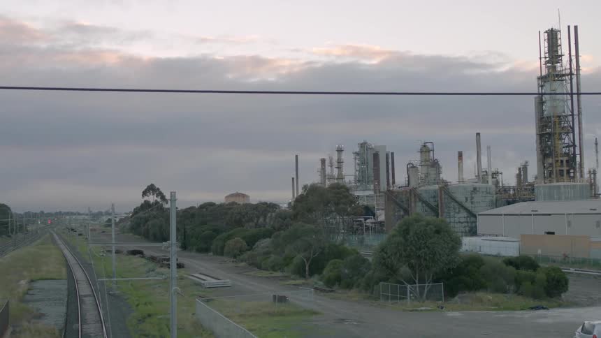 The sun is setting on the factory