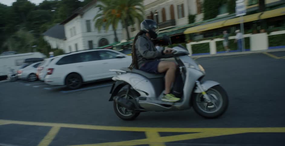 Person rides a motorbike on a curving road
