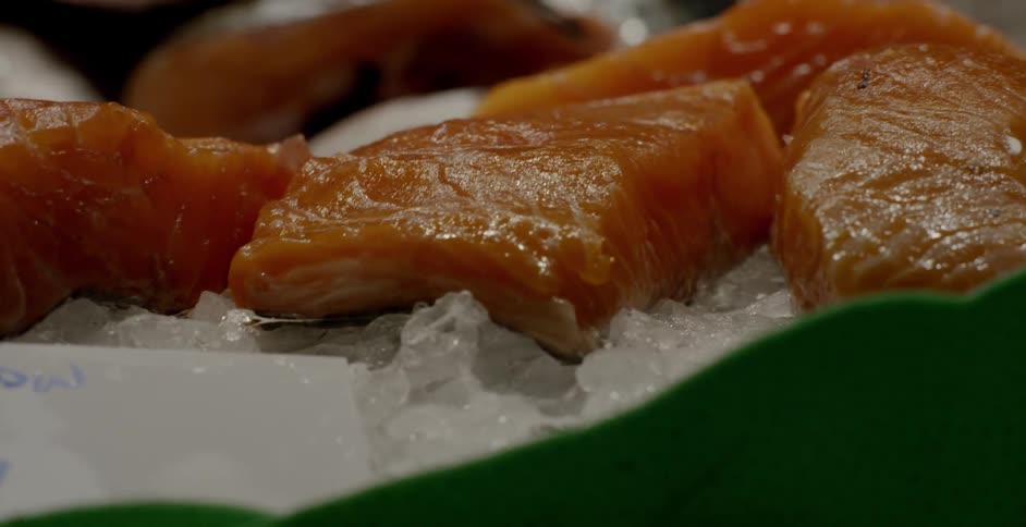 Cut fish is sitting on ice in this shop
