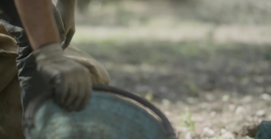 A man pulls a bucket out of a bag