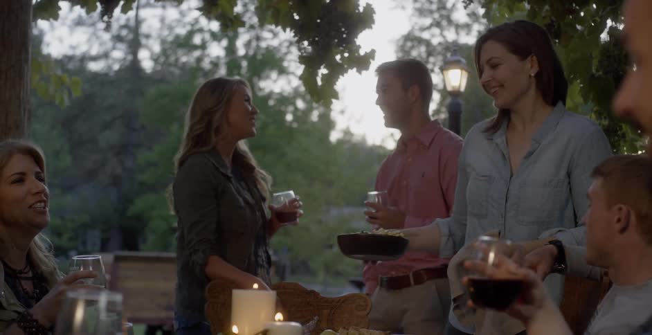 A group of people dine together outside