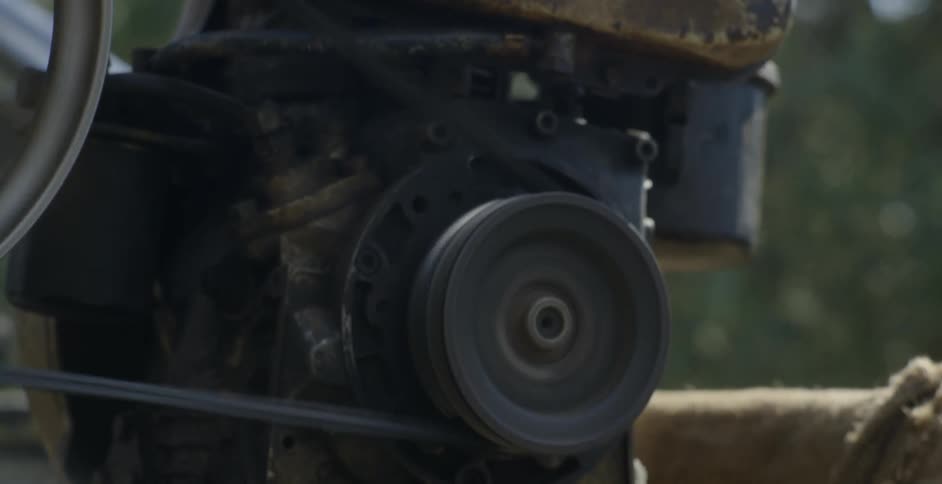 A belt drive motor spins