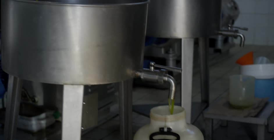 The vats are being filled with yellow liquid