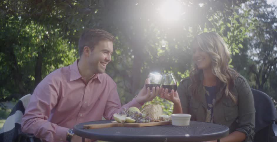 A man and woman toast before having a drink together