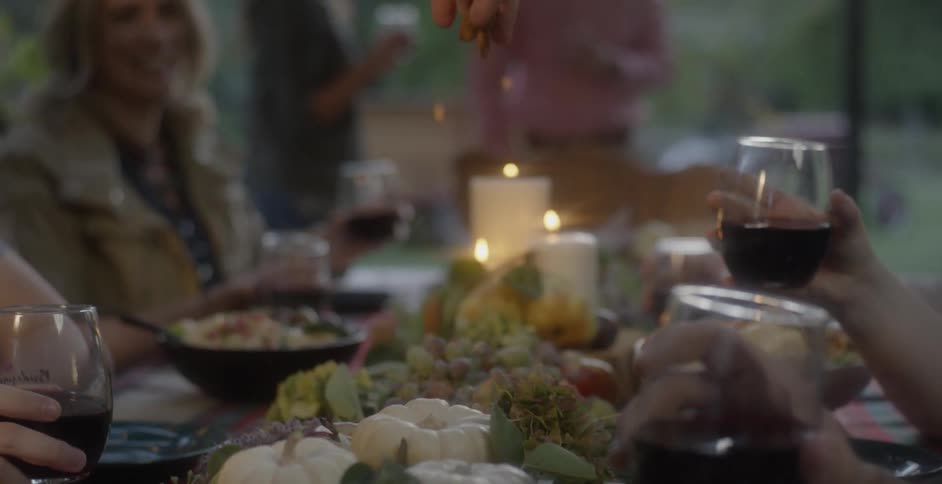 People sit around a table outside for a meal