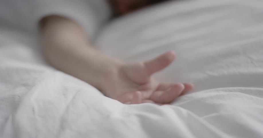 A small baby is laying in the bed