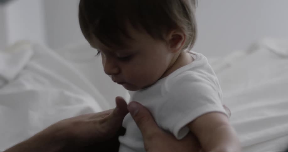 Man lies with a baby in bed