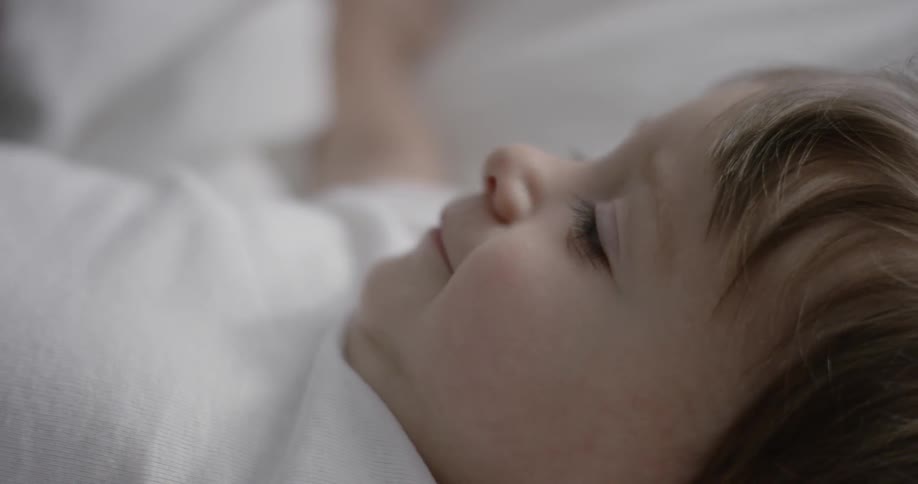 A baby smiles and looks around