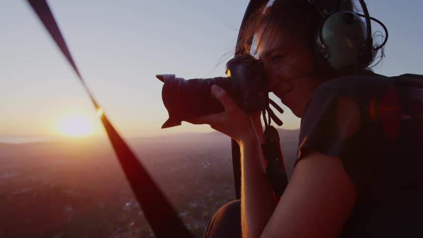 A woman is taking pictures from a plane