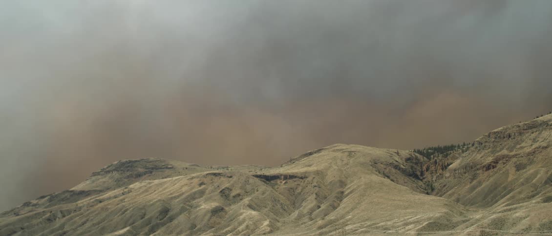 Haze drifts across the sky above the hills
