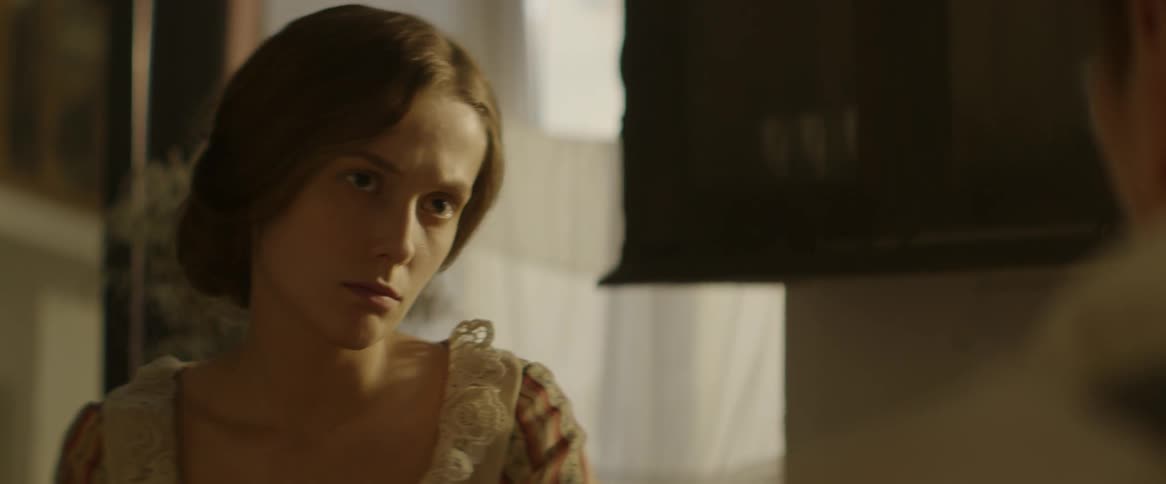 A woman looks concerned in a kitchen