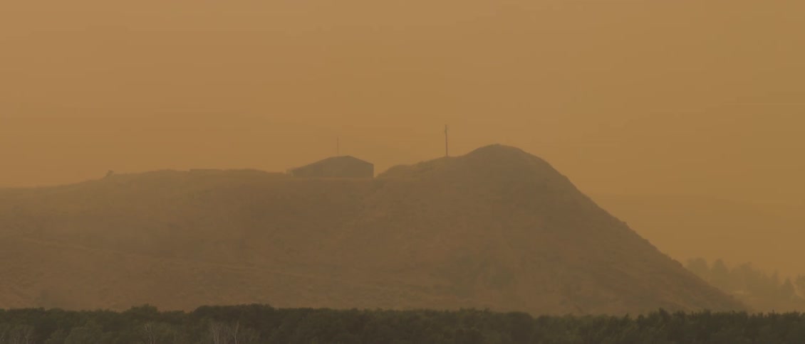The mountain is covered with fog at dawn