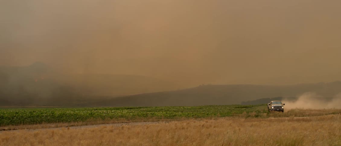 A man drives a truck on the farmland