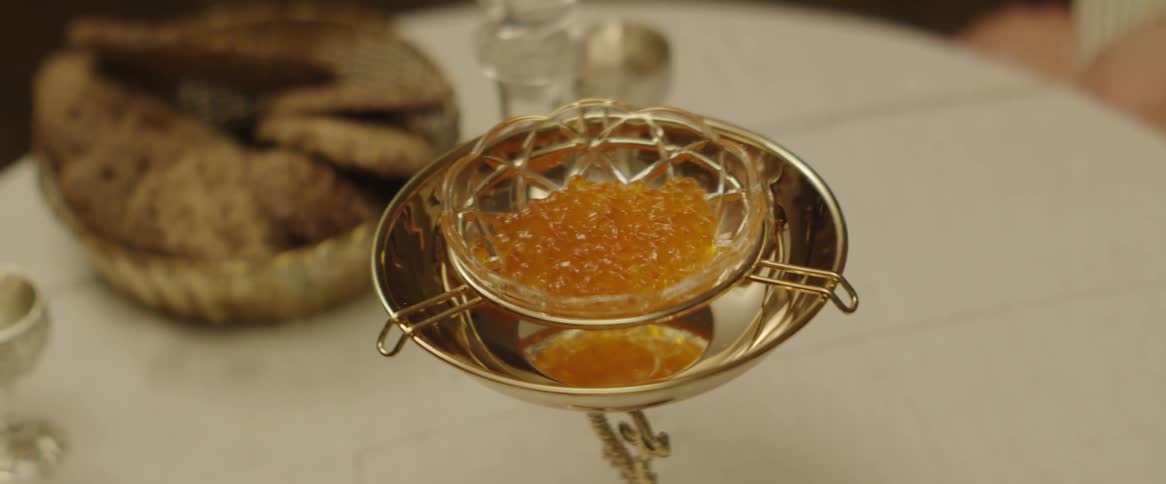 A dish of caviar sits on a dining table