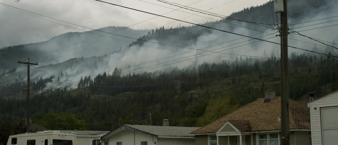 Smoke pours from a burning forest fire