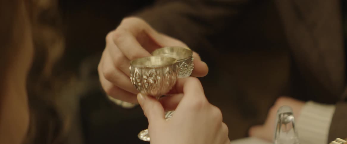 People toasting with tiny chalices with a nice design