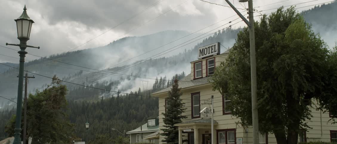 Smoke pours from a smoldering fire