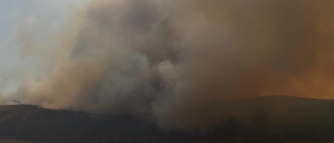 A wildfire burns in the mountains