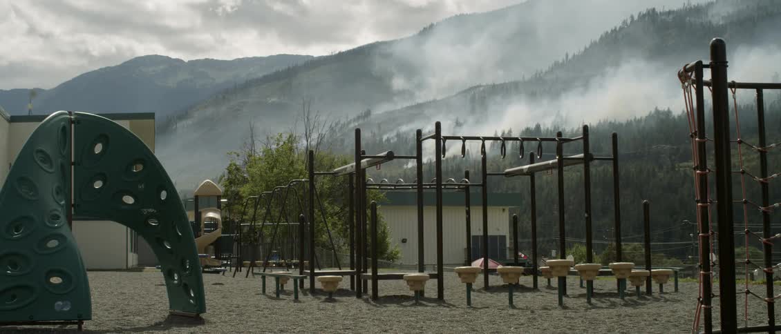 Behind the playground the hills are burning