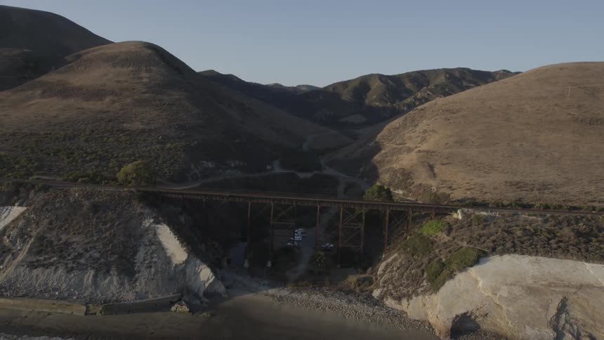 A bridge gaps two sides of a steep hill