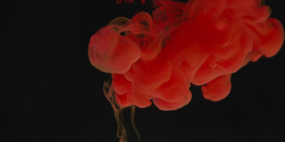 Red liquid billows in clear liquid